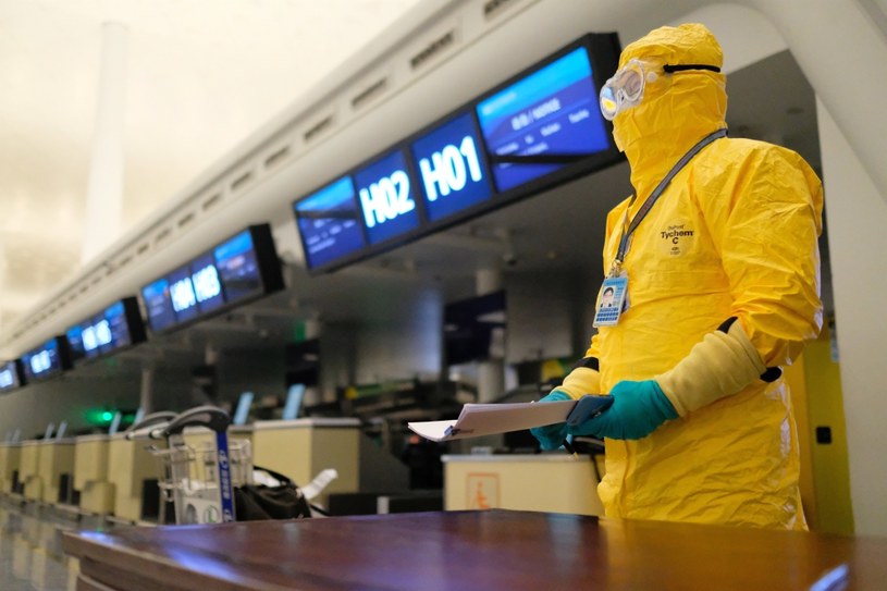 Pracownik lotniska w Wuhan w ochronnym ubiorze /PAP