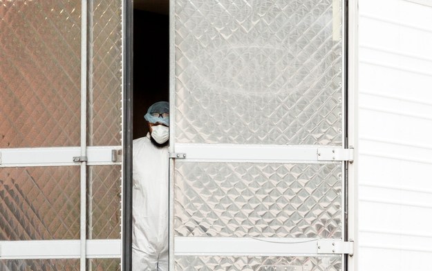 Pracownik nowojorskiego szpitala stojący przed tymczasową kostnicą /JUSTIN LANE /PAP/EPA