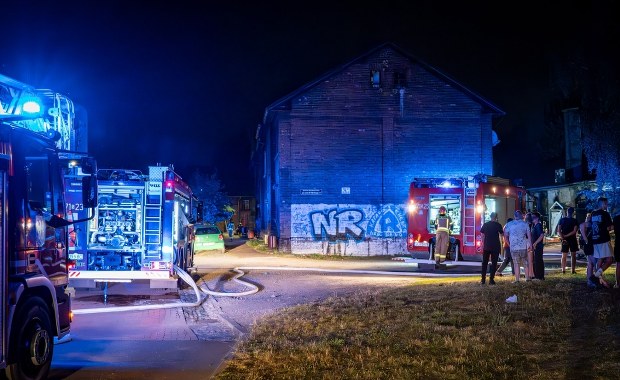 Przyczepa kempingowa w ogniu, zagrożony budynek. Ewakuacja mieszkańców