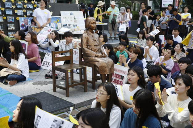 Setki młodych Koreanek zebranych się wokół pomnika, symbolizującego ofiarę wojennego niewolnictwa seksualnego, jaki stoi w pobliżu ambasady Japonii w Seulu. Zdjęcie pochodzi z września 2019 roku. /EPA/JEON HEON-KYUN /PAP