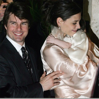 Tom Cruise i jego białe zęby oraz Katie Holmes z córeczką Suri /AFP
