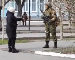 A Ukrainian woman confronts Russian soldiers. "You are the invaders"