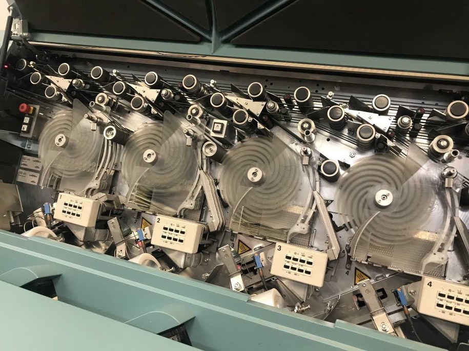 Wnętrze maszyny sortującej banknoty w Narodowym Banku Polskim. Błękitne maszyny układają banknoty w paczki (100 sztuk). Dziesięć paczek to wiązka (1000 sztuk banknotów). /Fot. Michał Dobrołowicz /RMF FM