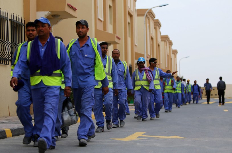 Zagraniczni pracownicy budujący stadiony w Katarze /AFP