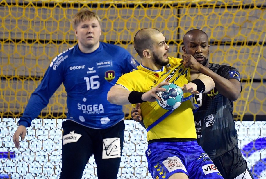 Zawodnik drużyny Łomża Vive Kielce Artiom Karalek (C) oraz bramkarz Emil Nielsen (L) i Rock Feliho (P) z zespołu HBC Nantes / 	Piotr Polak    /PAP